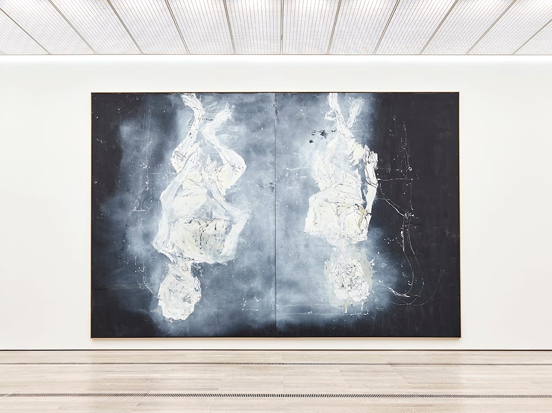 Baselitz painting of two people in white on the wall